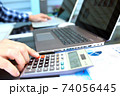 Businessman / accountant is doing calculations. Tax season. 74056445