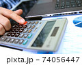 Businessman / accountant is doing calculations. Tax season. 74056447