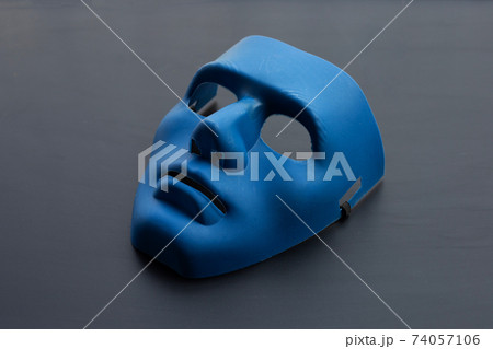 Blue face mask on dark background. 74057106