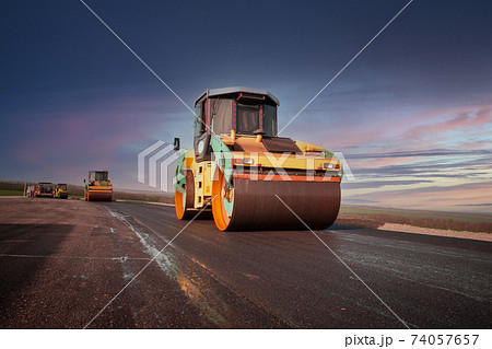 Large view on the road rollers working on the new road construction site 74057657