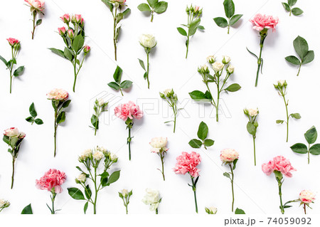 Texture made of roses and carnations, branches, floral pattern on a white background. The apartment lay, top view. Background For Valentine Day. Texture made of roses and carnations, branches, floral pattern on a white background. The apartment lay, top view. Background For Valentine Day. 74059092