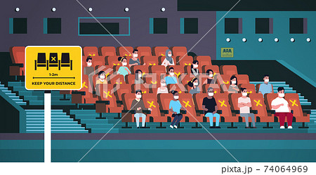 people in protective masks watching movie keeping distance to prevent coronavirus social distancing concept 74064969