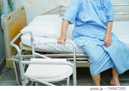 Asian senior woman patient with commode chair or mobile toilet can moving in bedroom or everywhere for elderly old disabled people or patient 74067205