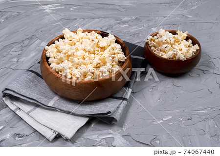 popcorn on the concrete gray background. fast food, corn, watching movies. 74067440