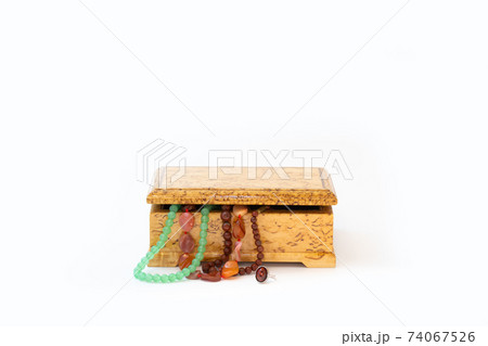 Jasper, agate and nephritis beads in wooden jewelry box and silver ring with amber isolated on white Jasper, agate and nephritis beads in wooden jewelry box and silver ring with amber isolated on white 74067526