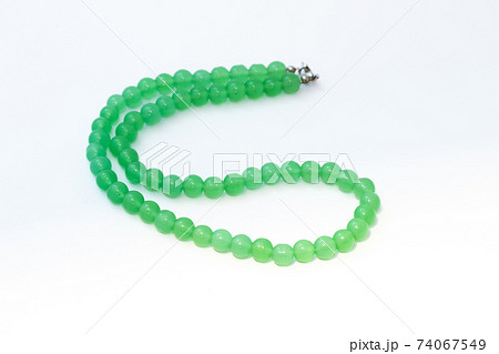 Green nephritis beads isolated on white background 74067549