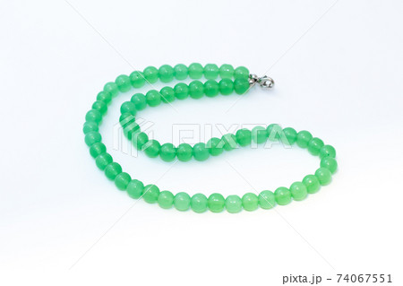 Green nephritis beads isolated on white background 74067551