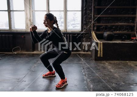 Young girl doing sports in the gym. Atmospheric gym 74068125