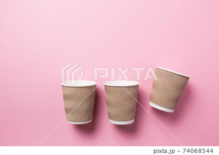 Paper cup for hot coffee or tea on a pink isolated background. 74068544