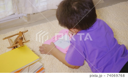 klid little boy preschool writing at the magnetic drawing board 74069768