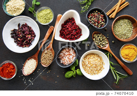 Various spices in a bowls on a black 74070410