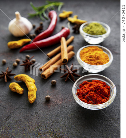Various spices in a bowls on a black 74070411