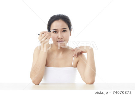 Beauty Asian girl with makeup brushes 74070872
