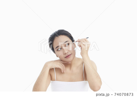 Beauty Asian girl with makeup brushes 74070873