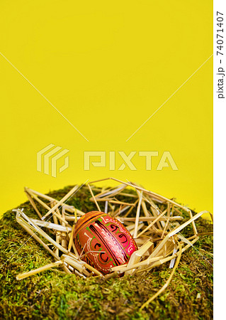 easter basket with easter eggs on Yellow background 74071407