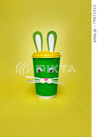 cardboard cup of coffee, with ears and a rabbit face 74071415