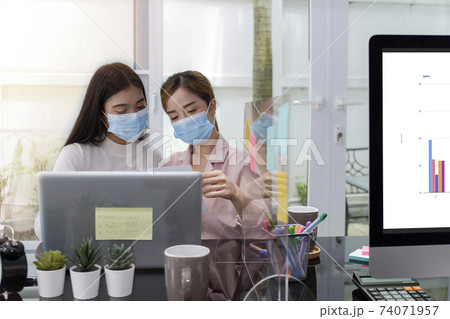 Asian Business Team Meeting Brainstorming Business start up working at Private Home Office social distancing among Coronavirus outbreak New generation business people meeting analysis work from laptop 74071957