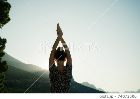 Young woman making yoga asana outside Young woman making yoga asana outside 74072506