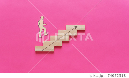 Paper cut silhouette of a businessman walking up the stairs 74072518