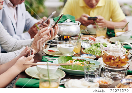 Family members with phones Family members with phones 74072570