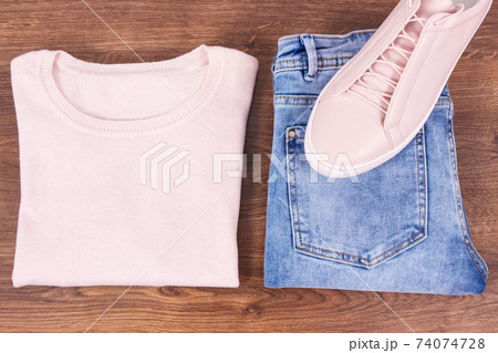 Womanly leather shoes, jeans pants and sweater on boards Womanly leather shoes, jeans pants and sweater on boards 74074728