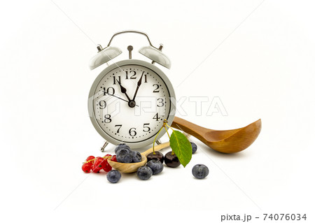 Culinary still life with clock, spoon and berries Culinary still life with clock, spoon and berries 74076034