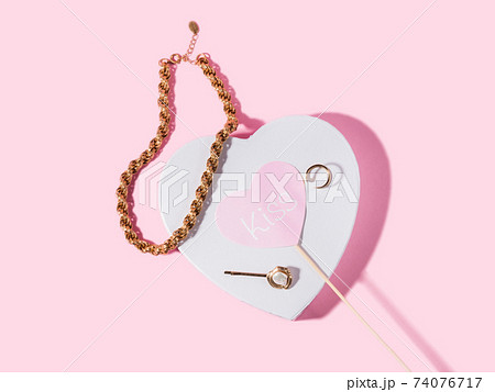 Fashion valentine backgound with golden jewelry on white heart shape podium Fashion valentine backgound with golden jewelry on white heart shape podium 74076717