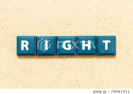 Tile alphabet letter in word right on wood background 74081421