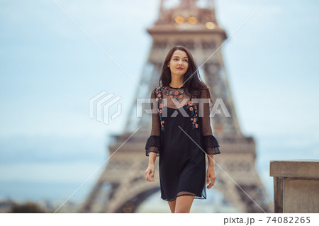 Parisian Woman Near the Eiffel Tower in Paris, France. Parisian Woman Near the Eiffel Tower in Paris, France. 74082265