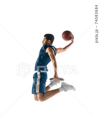 Young arabian basketball player of team in action, motion isolated on white background. Concept of sport, movement, energy and dynamic. 74083684