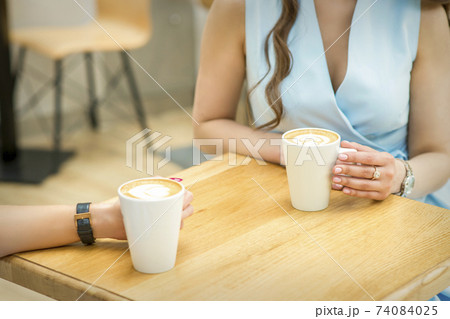 Female hands with cups of coffee 74084025