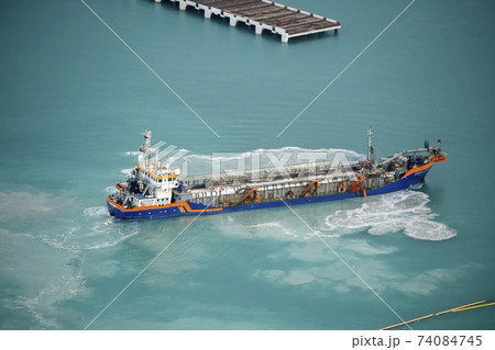 Suction Dredger Emptying Sluices, Spoiling Water of Gulf with mud Spot, Pollution, brown Muddy water - aerial shot 74084745