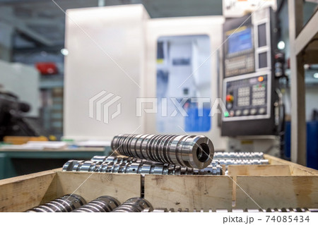 the steel part is large against the background of the cnc machine. Low-depth-of-field photography 74085434