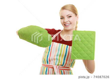 Smiling housewife in kitchen apron Smiling housewife in kitchen apron 74087026