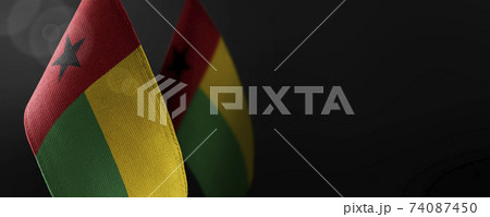Small national flags of the Guinea Bissau on a dark background Small national flags of the Guinea Bissau on a dark background 74087450