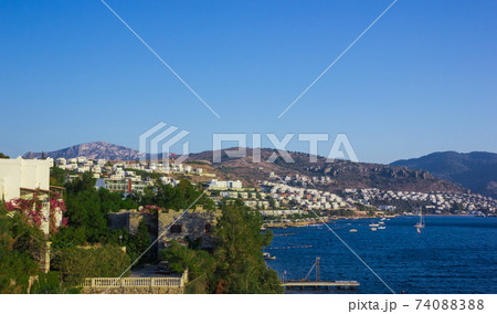 View of the Gumbet Bay. Mountainous terrain near the Aegean Sea. Typical buildings on the mountain near the sea. Bodrum. Turkey. View of the Gumbet Bay. Mountainous terrain near the Aegean Sea. Typical buildings on the mountain near the sea. Bodrum. Turkey. 74088388