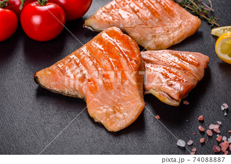 Tasty fresh red fish arctic char baked on a grill Tasty fresh red fish arctic char baked on a grill 74088887
