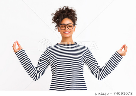 Young woman meditating with closed eyes 74091078