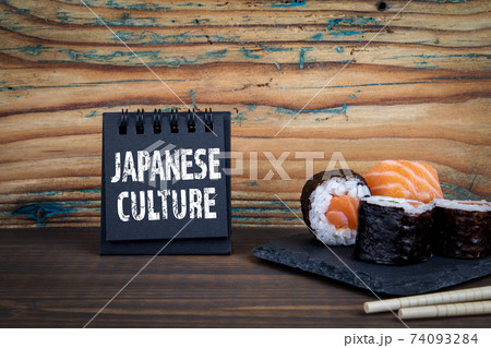 Japanese Culture. Notebook and sushi on wooden texture table 74093284