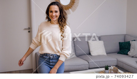 Young pretty woman in her living room 74093427