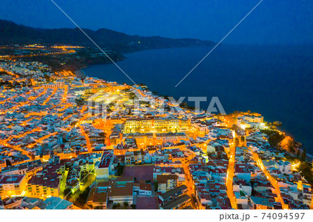 Illuminated view of coastal city of Nerja 74094597