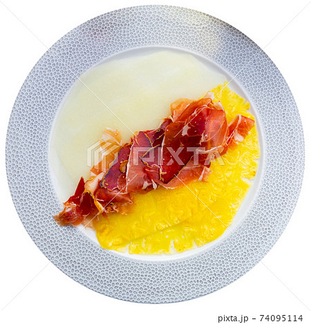 Delicious serving of pineapple and melon carpaccio with thinly sliced prosciutto Delicious serving of pineapple and melon carpaccio with thinly sliced prosciutto 74095114