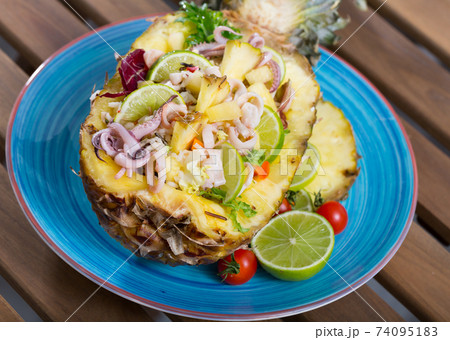 Salad with calamari, pineapple and lime 74095183