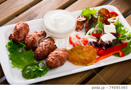 Kebets with tomatoes and peppers is tasty dish of Bulgarian cuisine 74095365