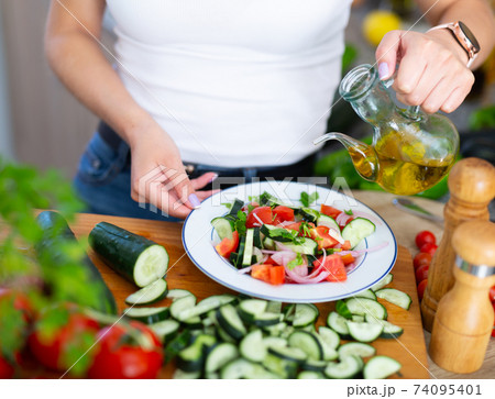 Cooking vegetable salad of cucumbers and tomatoes Cooking vegetable salad of cucumbers and tomatoes 74095401