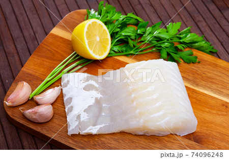 Rose eel fillet on cutting board with lemon and parsley. Rose eel fillet on cutting board with lemon and parsley. 74096248