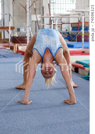 Woman training gymnastic elements Woman training gymnastic elements 74096325