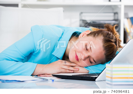 Office manager woman is sleeping after productive day at work Office manager woman is sleeping after productive day at work 74096481