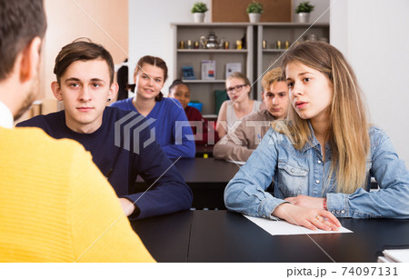 Students listening attentively teacher’s lecture Students listening attentively teacher’s lecture 74097131
