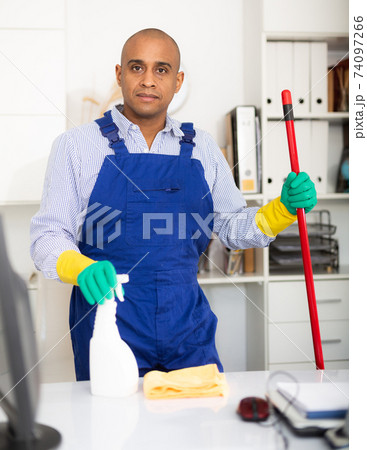 Cleaner in protective uniform at company office 74097266